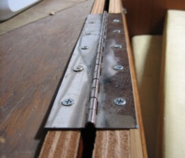 we used piano hinges scrounged from dismantling old table