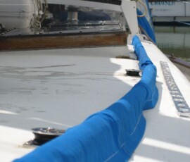 behind the two blocks, the line passes through a hole in the acrylic under the traveler